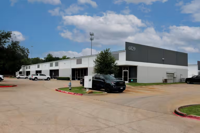 Building 6829 at Legacy Central Business Park with vehicles along the driveway.