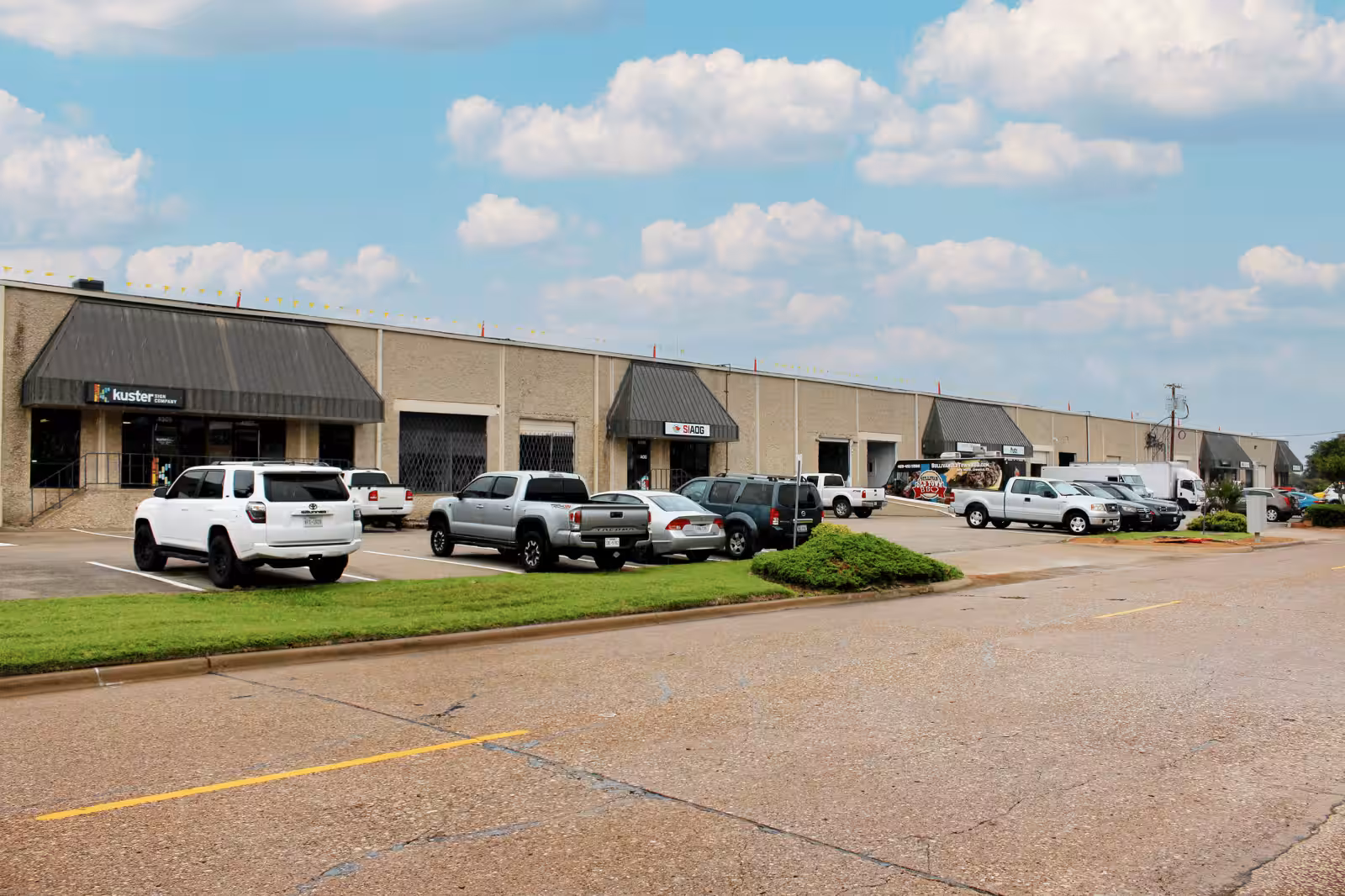 Commercial units at 4301 Lindbergh Drive with vehicles parked along the front.