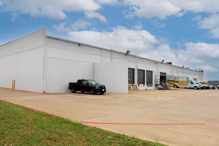 Skyway Circle Tech Center warehouse with loading docks and parked trucks.